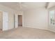 Large bedroom with carpeted floors and an ensuite bathroom at 26180 W Firehawk Dr, Buckeye, AZ 85396