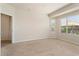 Bright bedroom with carpeted floor and window at 26180 W Firehawk Dr, Buckeye, AZ 85396