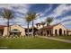 Community clubhouse with palm trees and lush landscaping at 26180 W Firehawk Dr, Buckeye, AZ 85396