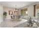 Virtually staged dining room with tile floors and patio access at 26180 W Firehawk Dr, Buckeye, AZ 85396