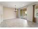 Dining area with tile floor, chandelier, and access to patio at 26180 W Firehawk Dr, Buckeye, AZ 85396