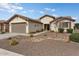 Charming one-story house with a two-car garage and nicely landscaped front yard at 26180 W Firehawk Dr, Buckeye, AZ 85396
