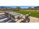Expansive firepit with seating area overlooking a grassy lawn at 26180 W Firehawk Dr, Buckeye, AZ 85396