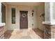 House entrance with a decorative wreath and stone flooring at 26180 W Firehawk Dr, Buckeye, AZ 85396