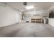 Garage with overhead storage, workbench, and epoxy floor at 26180 W Firehawk Dr, Buckeye, AZ 85396
