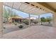 Relaxing patio area with pergola and gravel landscaping at 26180 W Firehawk Dr, Buckeye, AZ 85396