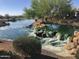 Community pond with a waterfall feature at 26180 W Firehawk Dr, Buckeye, AZ 85396