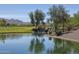 Serene pond with waterfall feature and mountain views at 26180 W Firehawk Dr, Buckeye, AZ 85396