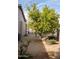 Landscaped backyard with lemon tree, gravel, and a decorative stone water feature at 3410 N 131St Ln, Litchfield Park, AZ 85340