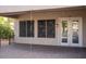 Covered patio with access to the backyard and features three windows and double doors at 3410 N 131St Ln, Litchfield Park, AZ 85340