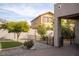 Landscaped backyard with artificial turf, gravel, and a view of the neighboring house at 3410 N 131St Ln, Litchfield Park, AZ 85340