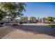Inviting backyard oasis with a sparkling pool and paved patio at 3410 N 131St Ln, Litchfield Park, AZ 85340