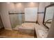Bathroom boasts a soaking tub, walk-in shower, and granite finishes at 3410 N 131St Ln, Litchfield Park, AZ 85340