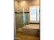 Spa-like bathroom with a shower and soaking tub at 3410 N 131St Ln, Litchfield Park, AZ 85340