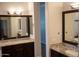 Elegant bathroom boasts double sinks, granite counters, and large mirrors at 3410 N 131St Ln, Litchfield Park, AZ 85340