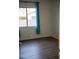 Bedroom with wood-look flooring and large window at 3410 N 131St Ln, Litchfield Park, AZ 85340