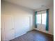 Bedroom featuring wood-look floors and blue window curtains at 3410 N 131St Ln, Litchfield Park, AZ 85340