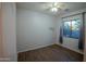 Bright bedroom with wood-look floors, ceiling fan, and window coverings at 3410 N 131St Ln, Litchfield Park, AZ 85340