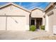 House exterior featuring a three-car garage and entryway at 3410 N 131St Ln, Litchfield Park, AZ 85340