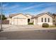 Tan two-story house with a three-car garage and landscaping at 3410 N 131St Ln, Litchfield Park, AZ 85340