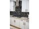 Modern kitchen with granite countertops and dark-colored backsplash at 3410 N 131St Ln, Litchfield Park, AZ 85340