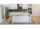 Gourmet kitchen features large island, granite countertops and white cabinets at 3410 N 131St Ln, Litchfield Park, AZ 85340