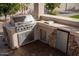 Outdoor kitchen with stainless steel appliances and stone countertops at 3410 N 131St Ln, Litchfield Park, AZ 85340