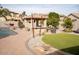 Relaxing pool area with a brick patio, built-in barbecue, and a grassy area at 3410 N 131St Ln, Litchfield Park, AZ 85340