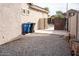 Side yard with gravel and trash receptacles at 3410 N 131St Ln, Litchfield Park, AZ 85340