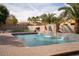 Refreshing swimming pool with a waterfall feature and a spacious patio area at 3410 N 131St Ln, Litchfield Park, AZ 85340