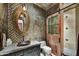 Elegant bathroom with a copper sink, mosaic tile, and a barn door at 38450 N 95Th Way, Scottsdale, AZ 85262