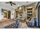 Relaxing bedroom with a cozy fireplace and built-in shelving at 38450 N 95Th Way, Scottsdale, AZ 85262