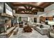 Open living room featuring a large sectional sofa and a stunning stone fireplace at 38450 N 95Th Way, Scottsdale, AZ 85262