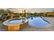 Inviting pool and spa surrounded by desert landscaping at 38450 N 95Th Way, Scottsdale, AZ 85262