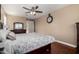 Bright bedroom with wood floors, ceiling fan, and large bed at 4315 N 154Th Dr, Goodyear, AZ 85395