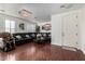 Living room with hardwood floors, sectional sofa, and large windows at 4315 N 154Th Dr, Goodyear, AZ 85395