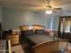 Primary bedroom with king bed, two night stands and ceiling fan at 4331 E Amberwood Dr, Phoenix, AZ 85048