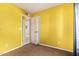 Bedroom with yellow walls and door to hallway at 4625 W Sheridan St, Phoenix, AZ 85035