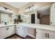 Bathroom with a large vanity and mirrored medicine cabinet at 4950 N Miller Rd # 210, Scottsdale, AZ 85251