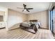 Spacious bedroom with wood-look floors and ceiling fan at 4950 N Miller Rd # 210, Scottsdale, AZ 85251
