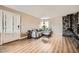 Living room featuring a stone fireplace and wood-look floors at 4950 N Miller Rd # 210, Scottsdale, AZ 85251