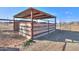 Wooden and metal horse corral with covered shelter at 50011 W Mayer Blvd, Maricopa, AZ 85139