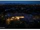 Nighttime aerial view of a luxury home with mountain views at 5939 E Quartz Mountain Rd, Paradise Valley, AZ 85253