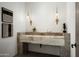 Elegant bathroom with double vanity, large mirror, and stone flooring at 5939 E Quartz Mountain Rd, Paradise Valley, AZ 85253