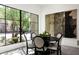 Elegant dining area with large windows and courtyard views at 5939 E Quartz Mountain Rd, Paradise Valley, AZ 85253