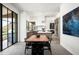 Open concept dining area with a live-edge wood table and black chairs, offering mountain views at 5939 E Quartz Mountain Rd, Paradise Valley, AZ 85253