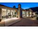 Backyard patio with mountain views at night at 5939 E Quartz Mountain Rd, Paradise Valley, AZ 85253
