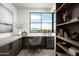 Home office with built-in desk and shelving, offering panoramic mountain views at 5939 E Quartz Mountain Rd, Paradise Valley, AZ 85253