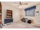 Bright bedroom with wood shelving, large window and ceiling fan at 74 S 94Th Pl, Chandler, AZ 85224