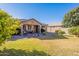 Home features a spacious backyard with patio furniture at 16140 W Almeria Rd, Goodyear, AZ 85395
